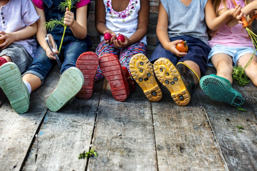 Group of kindergarten kids little farmers learning gardening Why Nanny Portugal